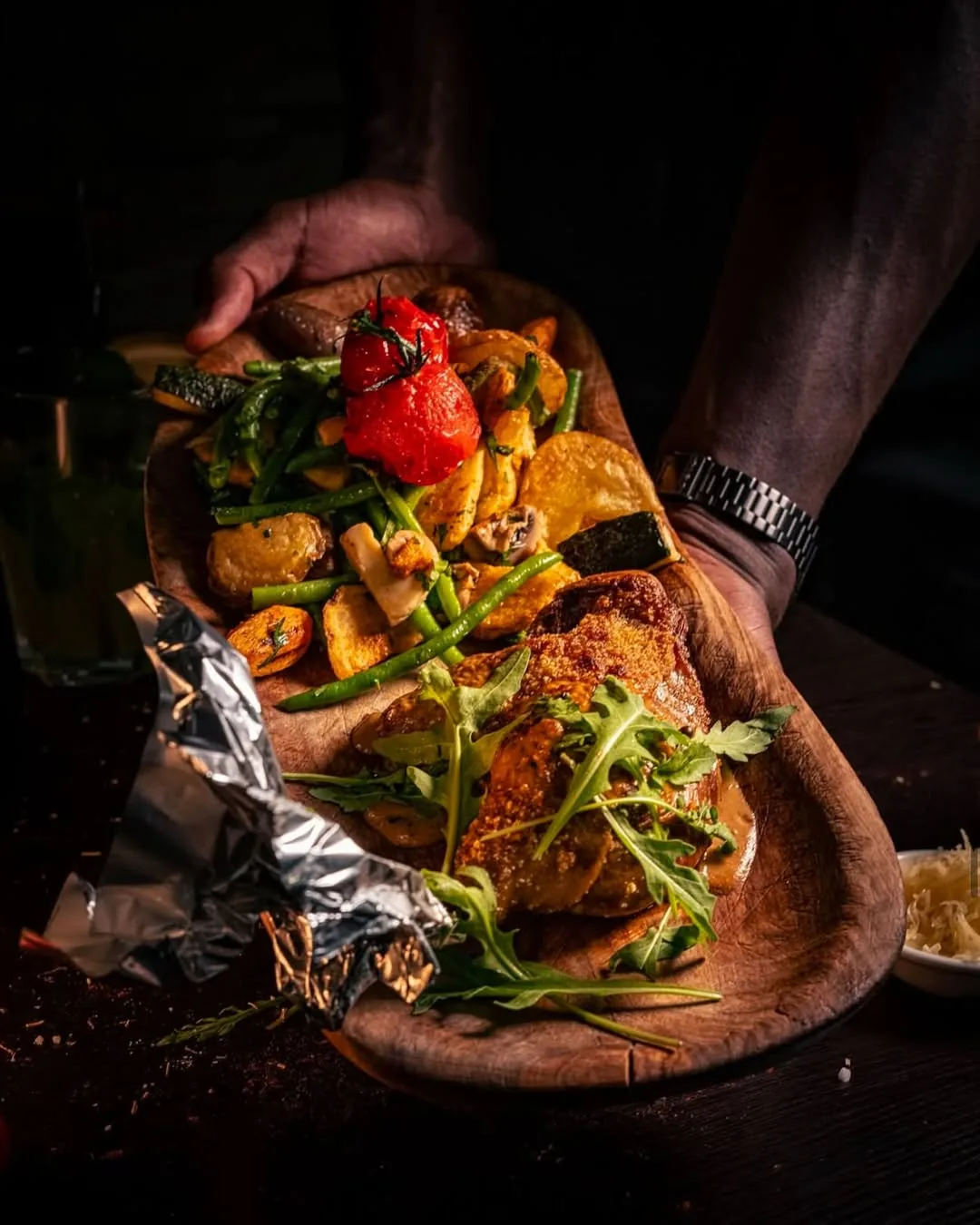 Halal duck confit on a wooden board, dramatic light