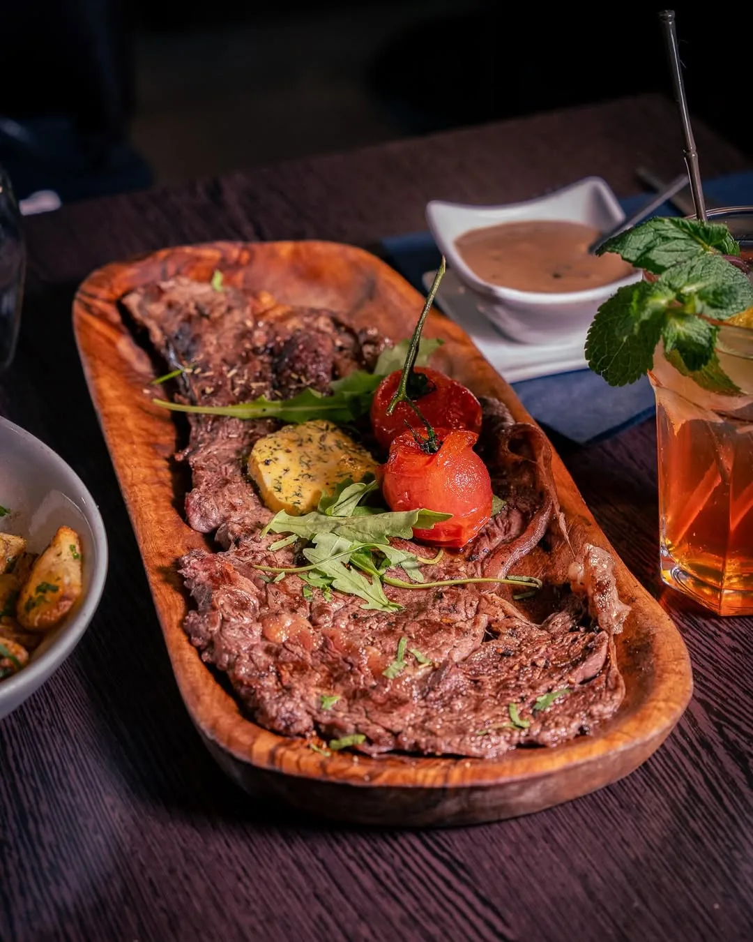 Halal grilled rib steak, mustard sauce, on a wooden board