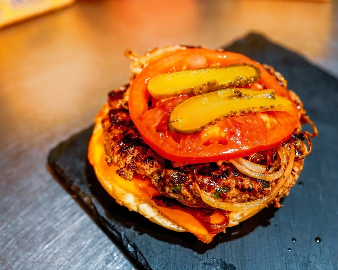 The chef's burger, melted cheddar, tomato, pickles